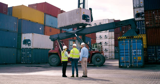 istock Cargo, container and supervisor talking to staff at commercial dock for supply chain logistics. Conversation, industrial shipping and planning with management team of people at harbor from back 2167775965