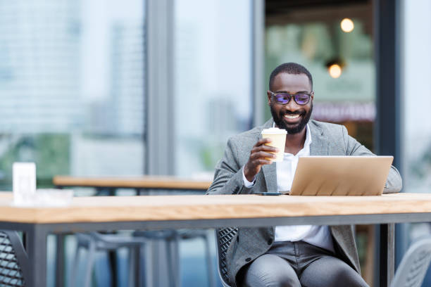 istock Businessman enjoying coffee and remote work in a cafe 2167779308