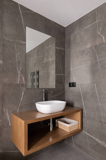 istock Modern bathroom interior with wooden vanity, vessel sink, and large mirror 2167779368
