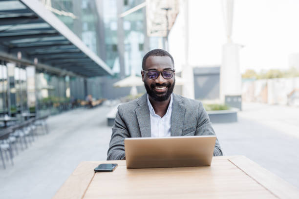 istock Confident businessman working on laptop in outdoor cafe setting 2167779415