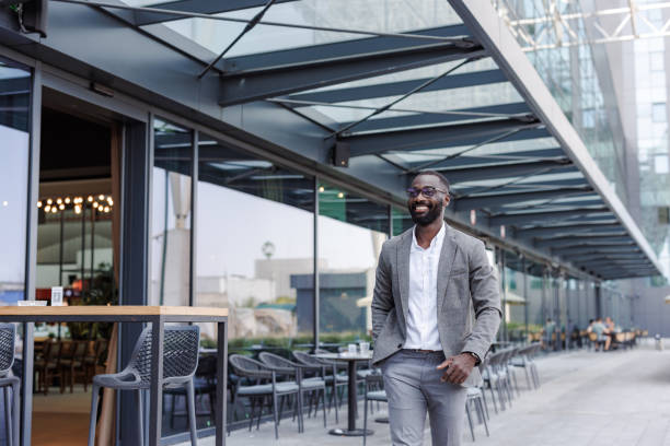istock Confident businessman walking outside modern office building 2167779521