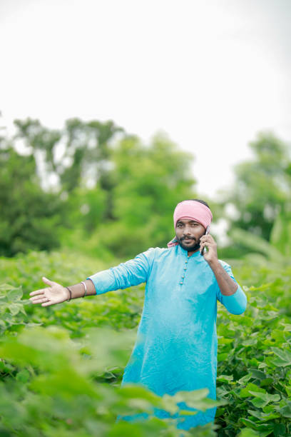 istock happy young Indian farmer using smart phone 2167779547