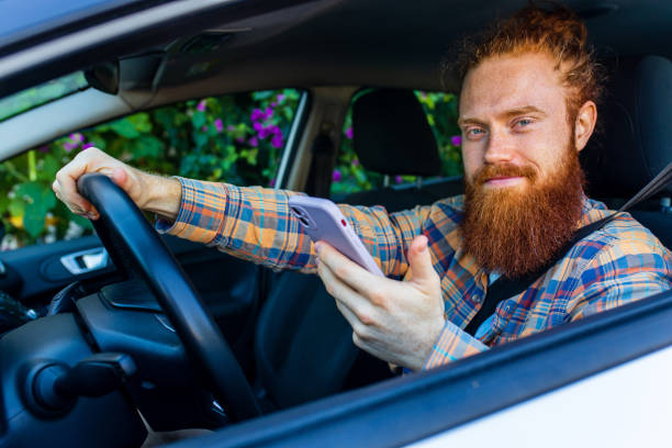 istock handsome redhaired ginger man with long beard going on trip during summer vacation on new car 2167780320