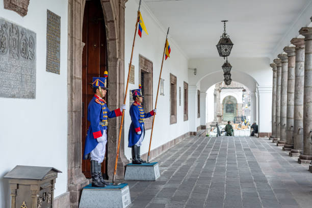 Quito, Pichincha, Ecuador - November 2013: Guards dressed up as soldiers from the 19th century, keep watch at the entrance of the Presidential Palace.