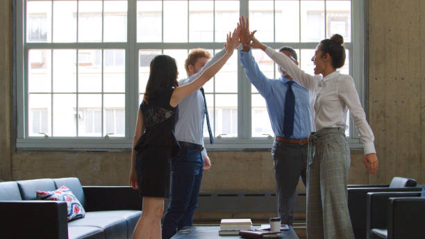 istock Multi-Cultural Business Team Celebrating Giving Each Other High Five In Modern Office 2167783071