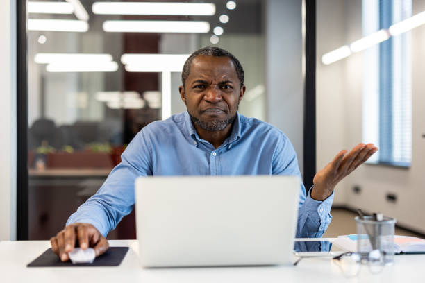 istock Confused businessman working on laptop in modern office 2167783656