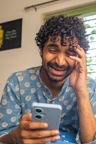 istock Happy young man texting over smart phone at home 2167788226