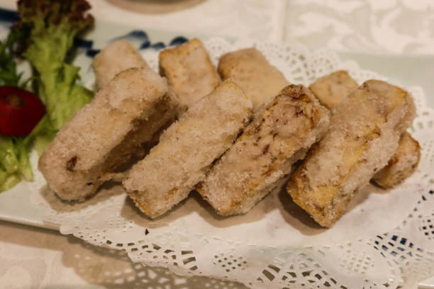 Chiu Chow Deep-fried Taro tossed with Sugar close up of Chinese chaozhou style Chiu Chow Deep-fried Taro tossed with Sugar on a white plate chaozhou guangdong stock pictures, royalty-free photos & images