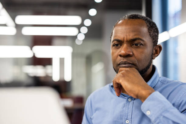 istock Focused African American office worker deep in thought at workplace 2167790292