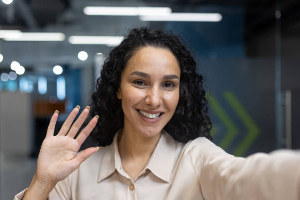 istock Smiling woman waving during office video call, friendly corporate communication 2167797890