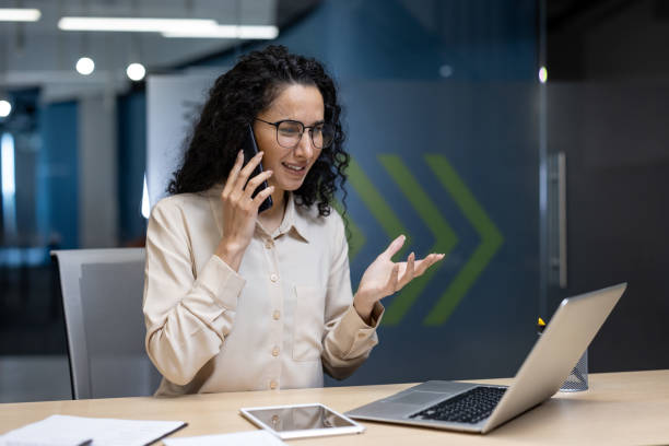 istock Businesswoman on phone call while working on laptop in office setting 2167798609