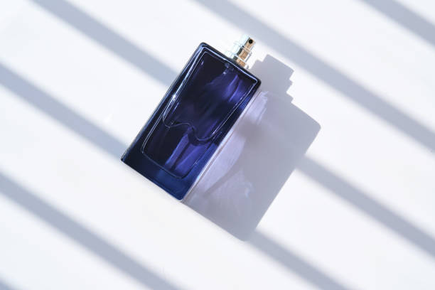 Perfume spray in a blue bottle on a white background. High quality photo.