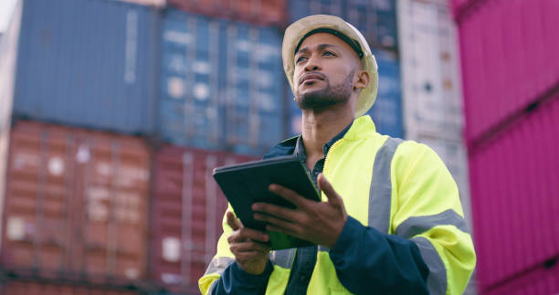 istock Tablet, man and logistics worker with containers for cargo inventory for international freight distribution. Technology, shipping and male load planner with stock for global supply chain at port. 2167799327