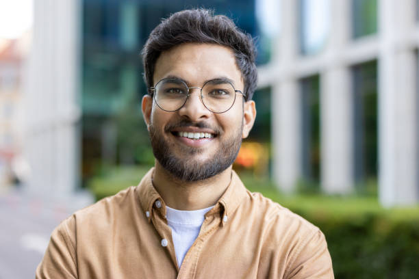 istock Confident hispanic man with glasses smiling outside modern building 2167799706