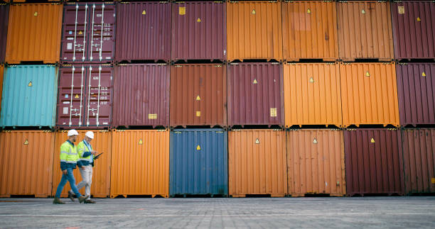 istock Container, inspection and tablet with men walking at shipping yard for logistics or supply chain. Checklist, storage and teamwork on cargo background for management of delivery, export or import 2167803128