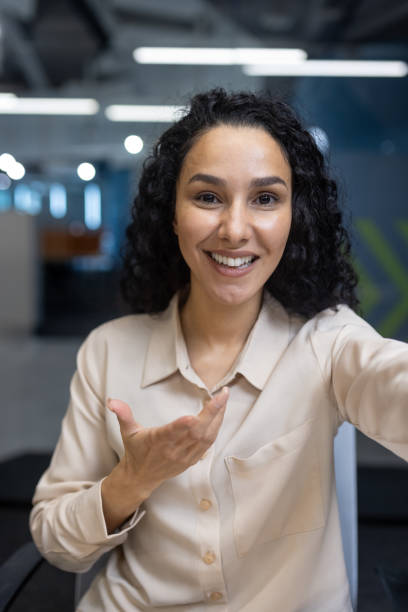 istock Woman on video call talking and looking at camera in office setting 2167803525