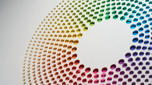 Concentric circular pattern of perforated dots forming a smooth gradient of colors on a light background.
