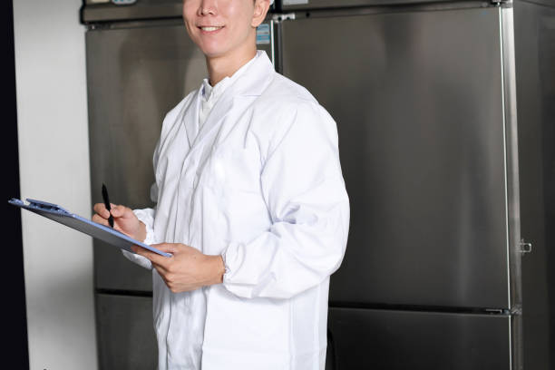 istock Asian man wearing sanitary clothes inspecting kitchen equipment 2167803961
