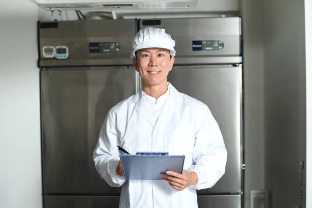 istock Asian man wearing sanitary clothes inspecting kitchen equipment 2167804822