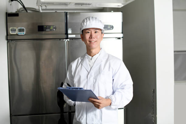 istock Asian man wearing sanitary clothes inspecting kitchen equipment 2167804826