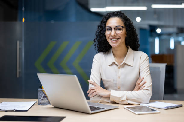 istock Confident Hispanic businesswoman smiling in office setting 2167805235