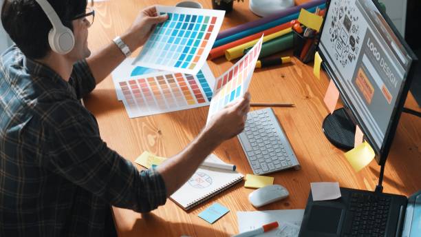 istock Designer look at screen and design color while looking at palette. Symposium. 2167807012