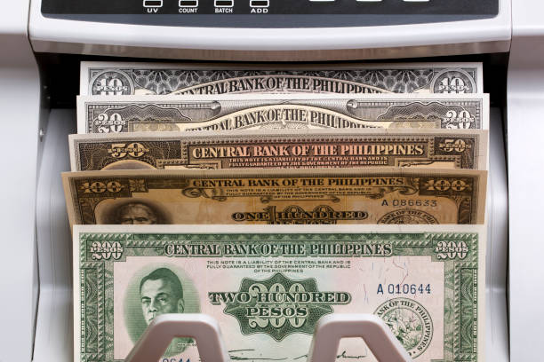 istock Old Philippine peso in the counting machine 2167807854
