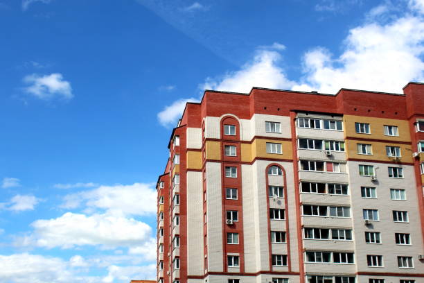 Multi-storey building with balconies against the sky on a sunny day.