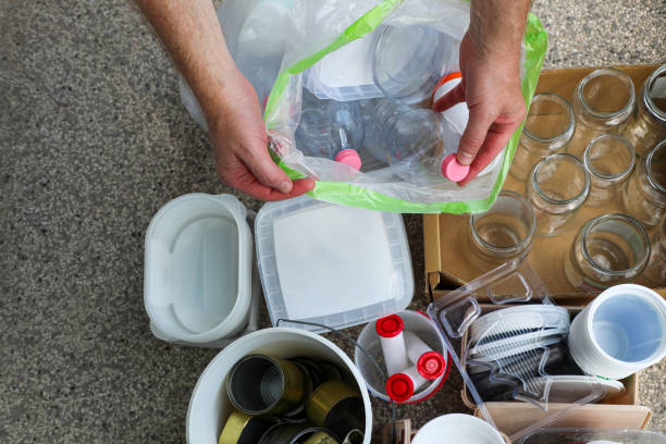 istock A person sorts household waste (plastic, glass, etc.) to throw it into appropriate garbage bins. Garbage sorting is very important in the modern world to solve many social issues. 2167808615
