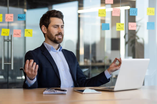 istock Businessman practicing mindfulness at the office desk for stress relief in modern workplace 2167809411