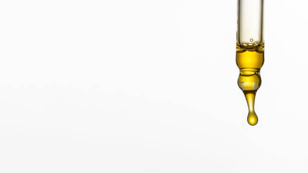 istock Dripping cosmetic serum from pipette on white background. Face serum. Copy space 2167810456