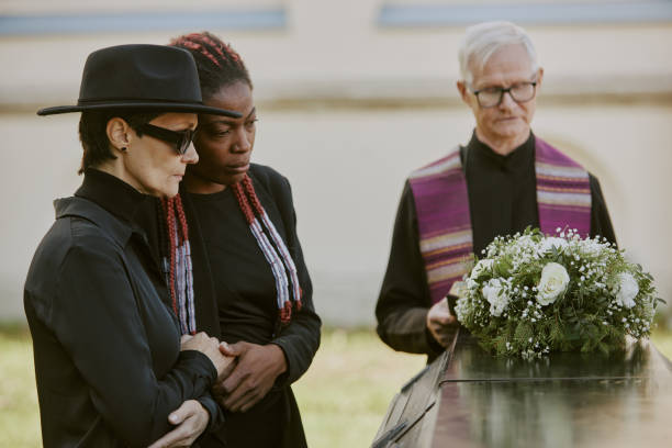 istock Mom and Daughter Crying at Cemetery 2167810528
