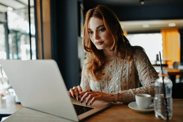 istock Beautiful Female Focused On Laptop Work During Coffee Time 2167810763