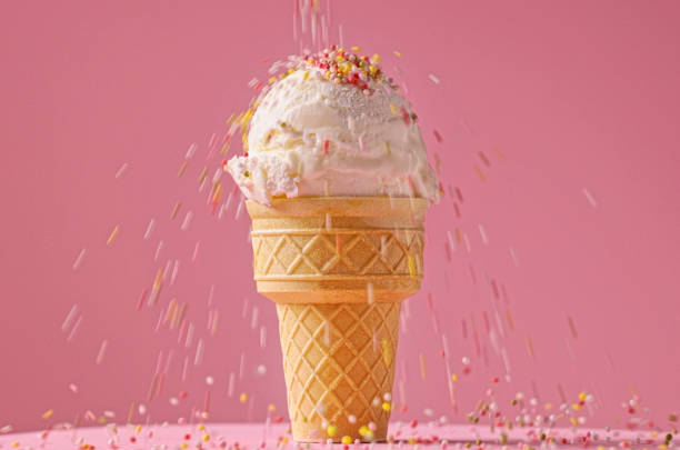 istock vanilla ice cream ball with falling sugar sprinkles 2167811155