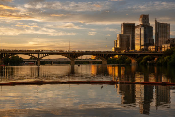 On this Austin, Texas landmark bridge, hundreds of people line up to catch a glimpse of a surreal natural phenomenon.  Under this bridge resides the world's largest urban colony of bats.  Around 1 million bats spend their summers under this famous bridge over the Lady Bird Lake (originally crossed over the Colorado River).