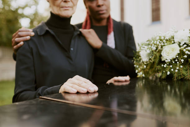 istock Female Hands on Coffin 2167812166