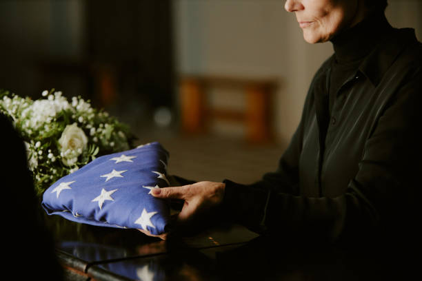 istock Woman Putting Flag on Coffin 2167813784