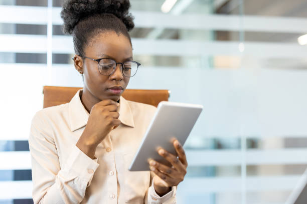 istock Focused businesswoman using digital tablet in modern office environment 2167815533
