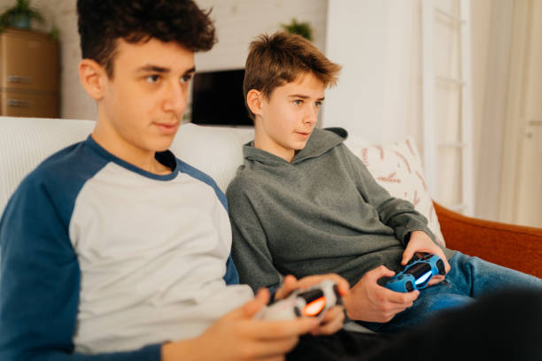 istock Boys having fun playing video games with joystick at home 2167815863