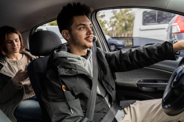 istock Taxi driver riding in car with passenger 2167816044
