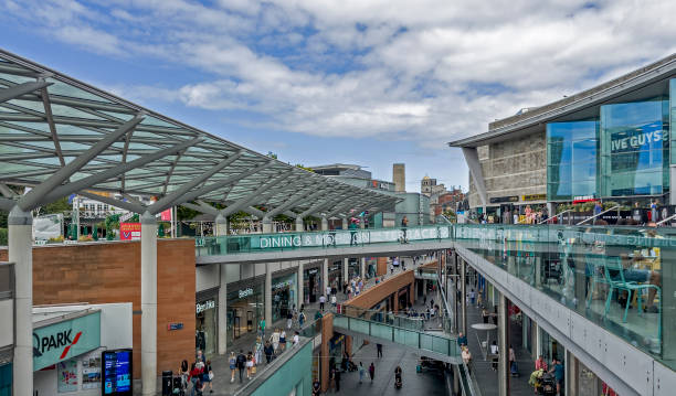 View of a busy shopping street in the centre of Liverpool, UK Shops can be seen on either side of the photograph and people can be seen walking on the pavements.