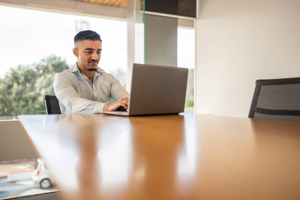 istock Focused Young Professional Working on Laptop in a Bright Office 2167817667