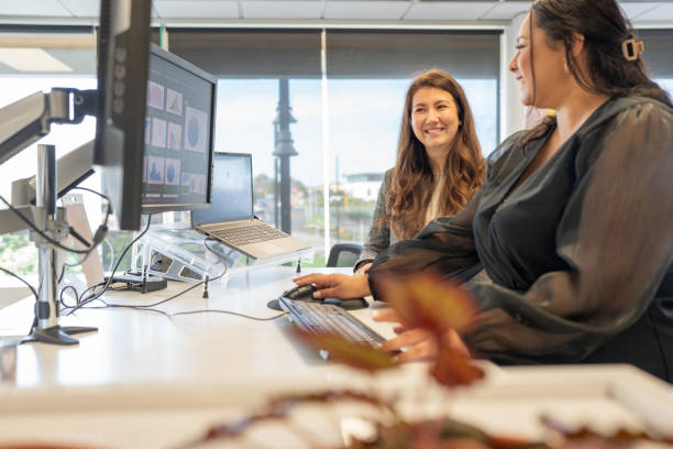 istock Happy Female Colleagues Collaborating at a Workstation 2167817766