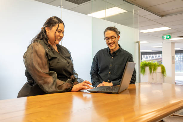 istock Colleagues Collaborating Over a Laptop in a Bright Office Space 2167817805