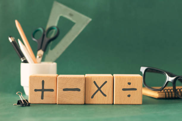 istock Basic mathematical operation symbols (Plus, minus, multiply, divide) on the wooden cube. Mathematic, education, back to school concept. Composition for Teacher's day. 2167819162