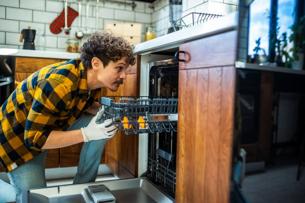 istock Latino man fixing dishwasher in the kitchen. 2167819217