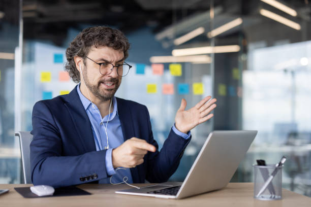 istock Confident businessman speaking during video call in modern office with sticky notes on glass wall 2167819222