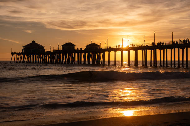 This classic silhouette of a pier crossing over sunset-reflected waters is a beautiful sight to capture anytime in California.  The tourists walk the popular pier as their family and friends swim through the lively waves.  Every year, the US Open of Surfing is held at Huntington Beach, attracting thousands to the beautiful SoCal coastline.