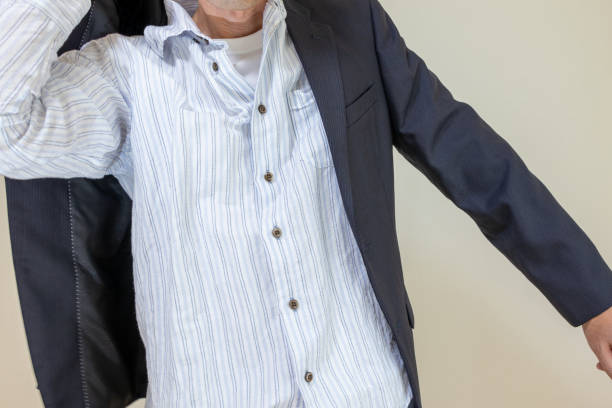 A man wearing a black jacket over a shirt