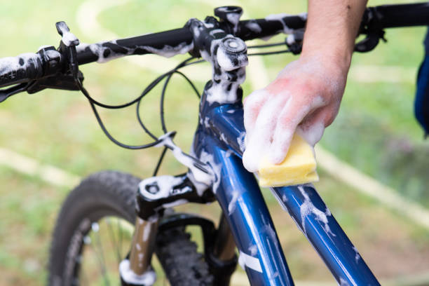 istock Man washing bicycle with sponge and soap, close up 2167825546